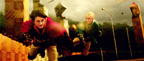 Draco Malfoy elbowing Harry Potter out of the way while playing Quidditch.